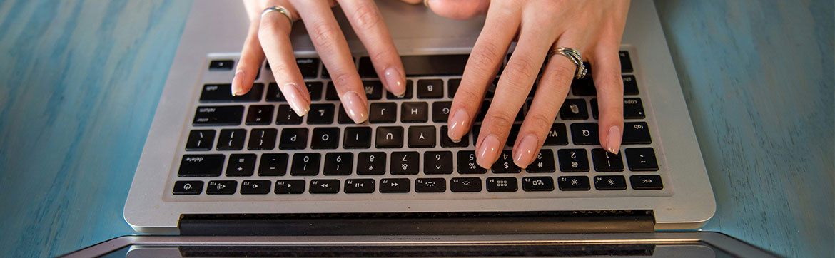 Someone typing at a computer