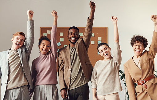 A group of students enthusiastically punching the air