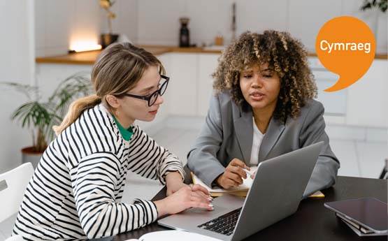 A lecturer giving a student one to one support