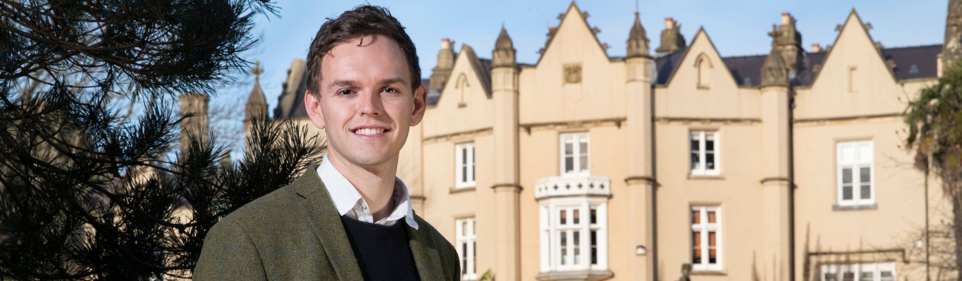 Sam Blaxland standing in front of Singleton Abbey.