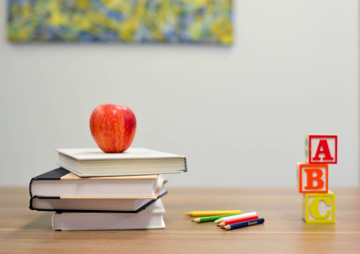 Apple on a pile of books. 