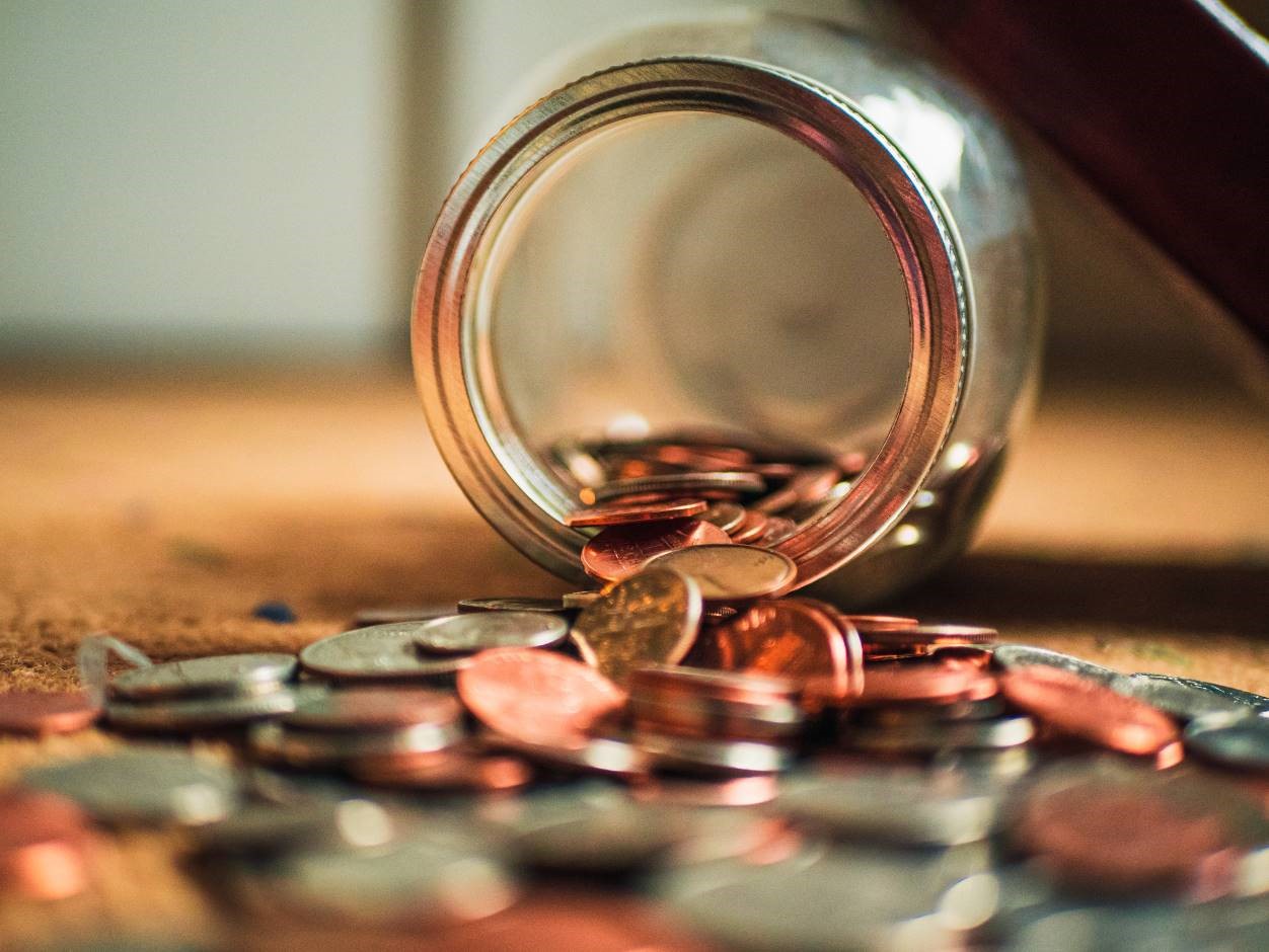 Coins falling out of a jar. 