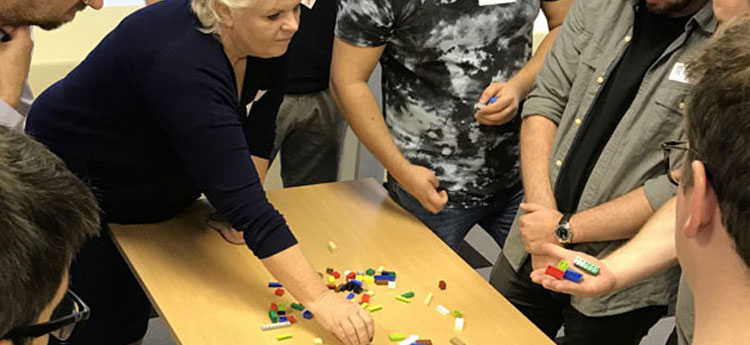 Woman moving coloured blocks on a table as part of a training exercise