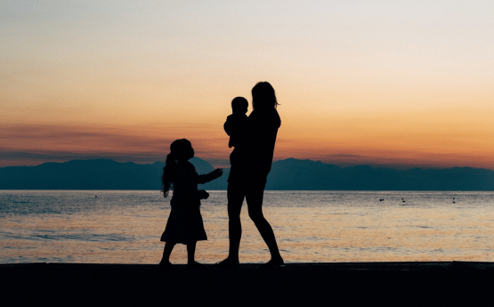 A family on the beach at sunset