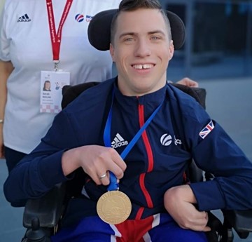 David Smith holding a gold medal