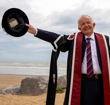 Dewi Meirion Lewis graduating on the beach