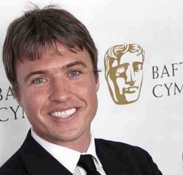 Jonny Owen in front of a BAFTA backdrop