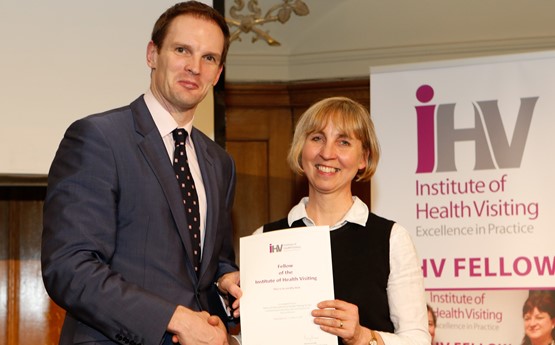 Louise receiving an award, shaking hands