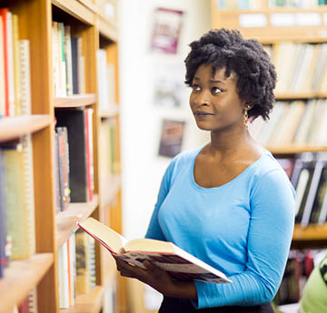 student in library