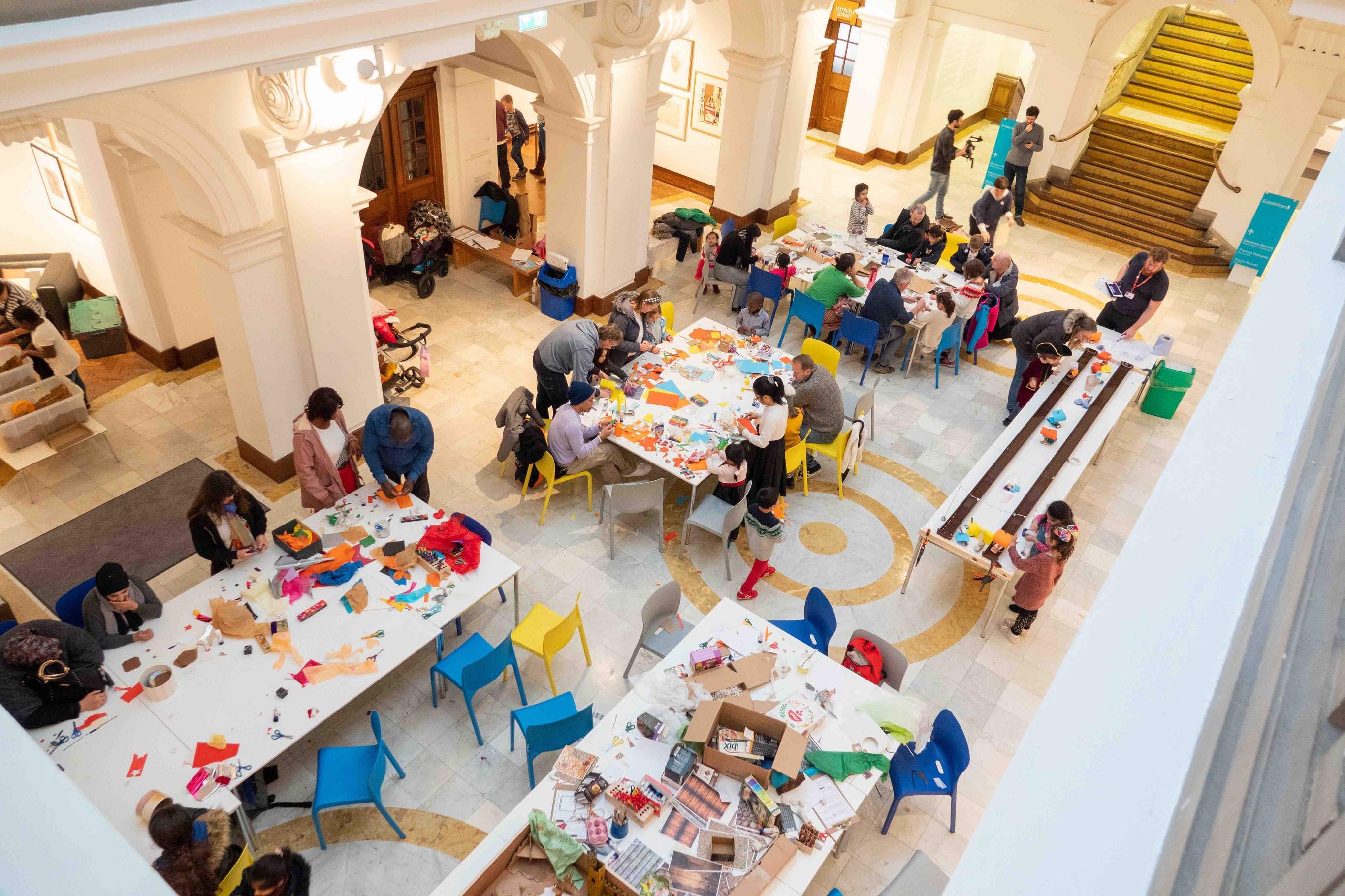 Groups of people doing crafts at white tables