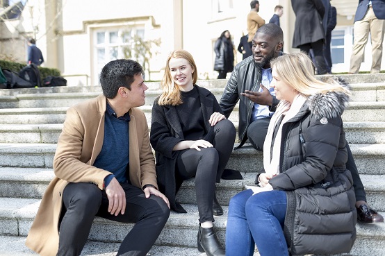 Students sitting on steps and talking