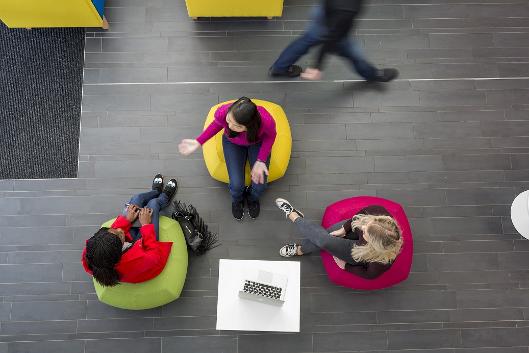 Three students sitting on bean bag