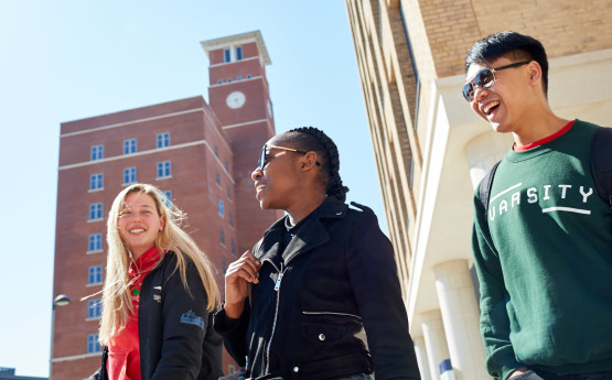 Students walking beside Bay CampusTower