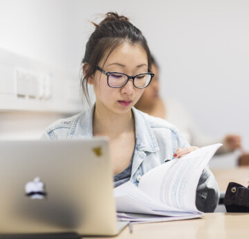 Student at laptop reading documents