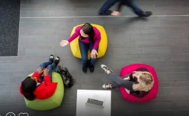 People sitting on colourful chairs