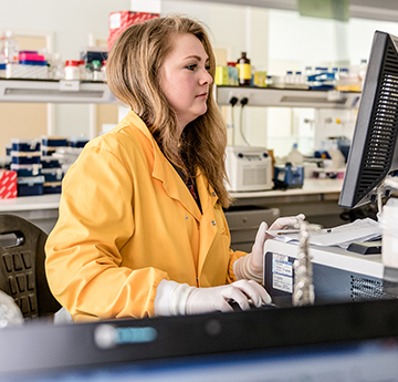 Researcher in yellow Lab Coat