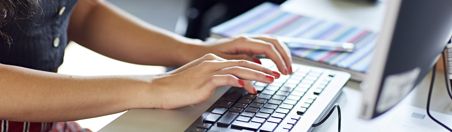 student typing on keyboard