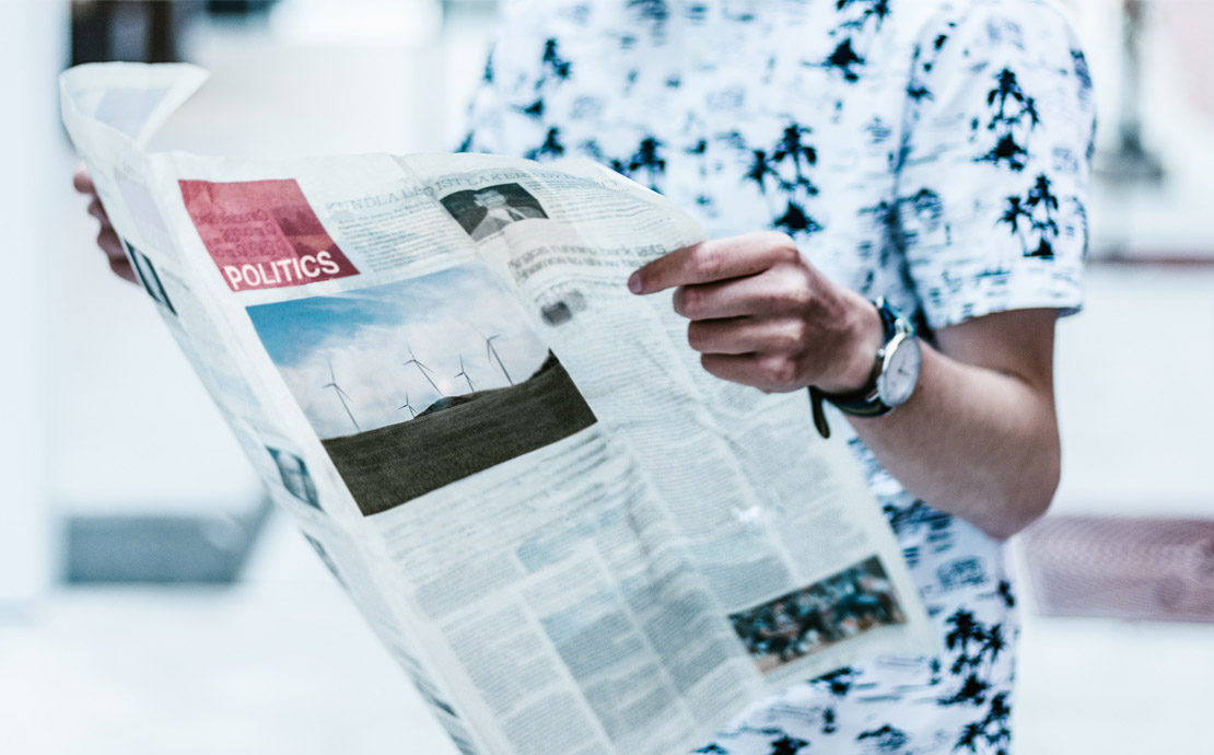 a person reading a newspaper