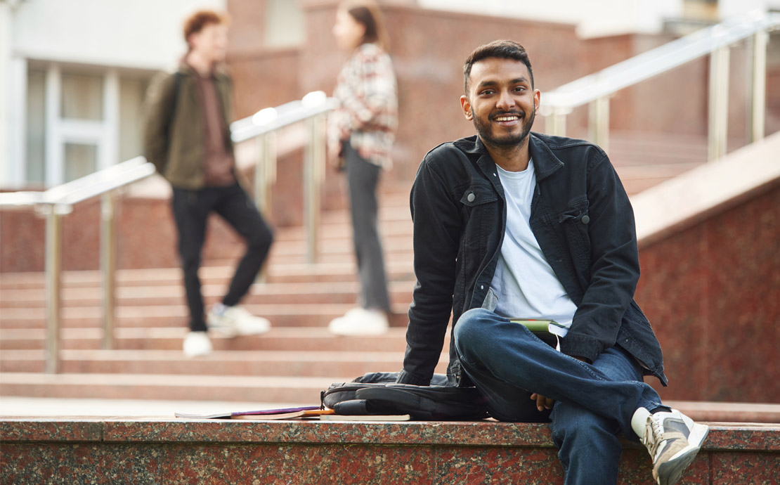 A student sitting on a wall