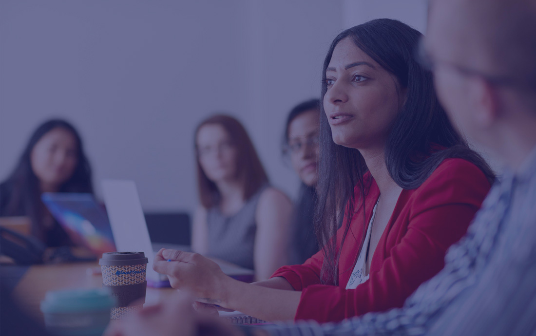 A group of people in a meeting