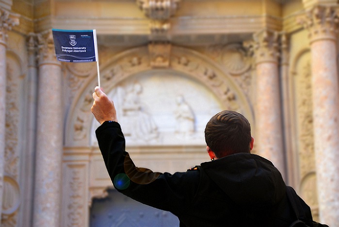 language student with swansea university flag