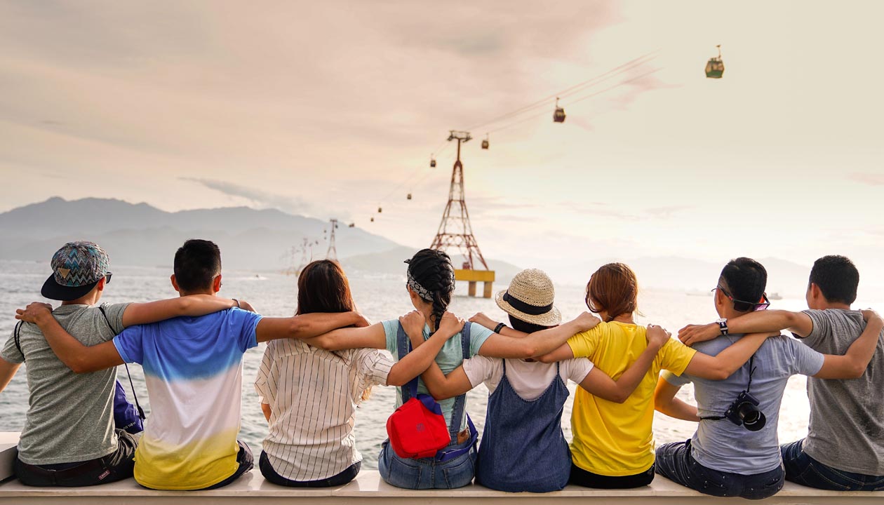 A row of people sitting arm in arm