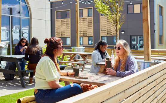 Students drinking coffee on bay campus