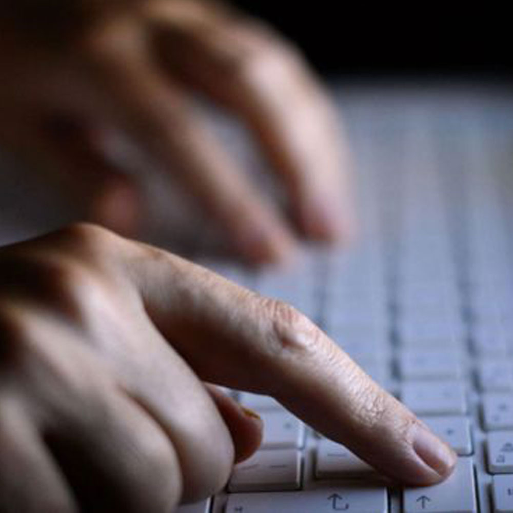 hands typing on a keyboard