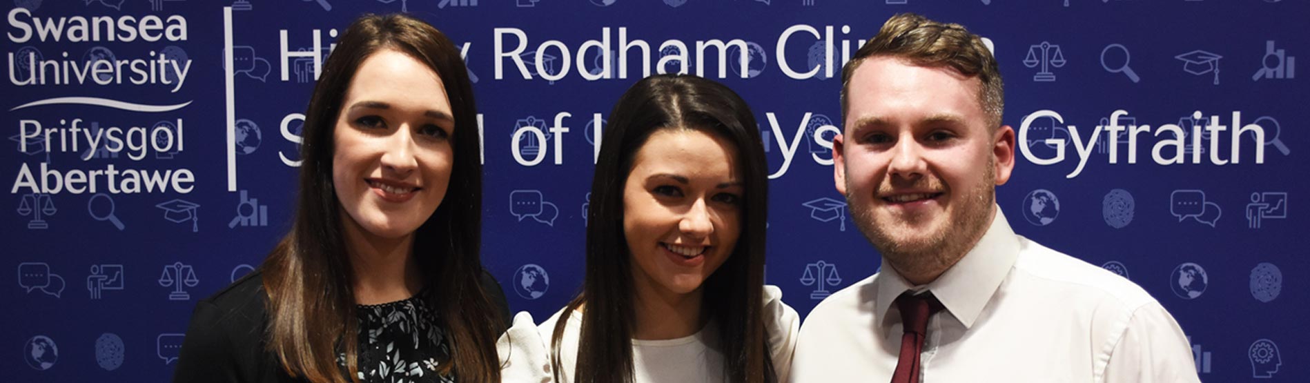 three lpc graduates having their photo taken at their graduation ceremony