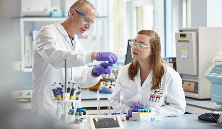 Lecturer and student conducting research in a lab