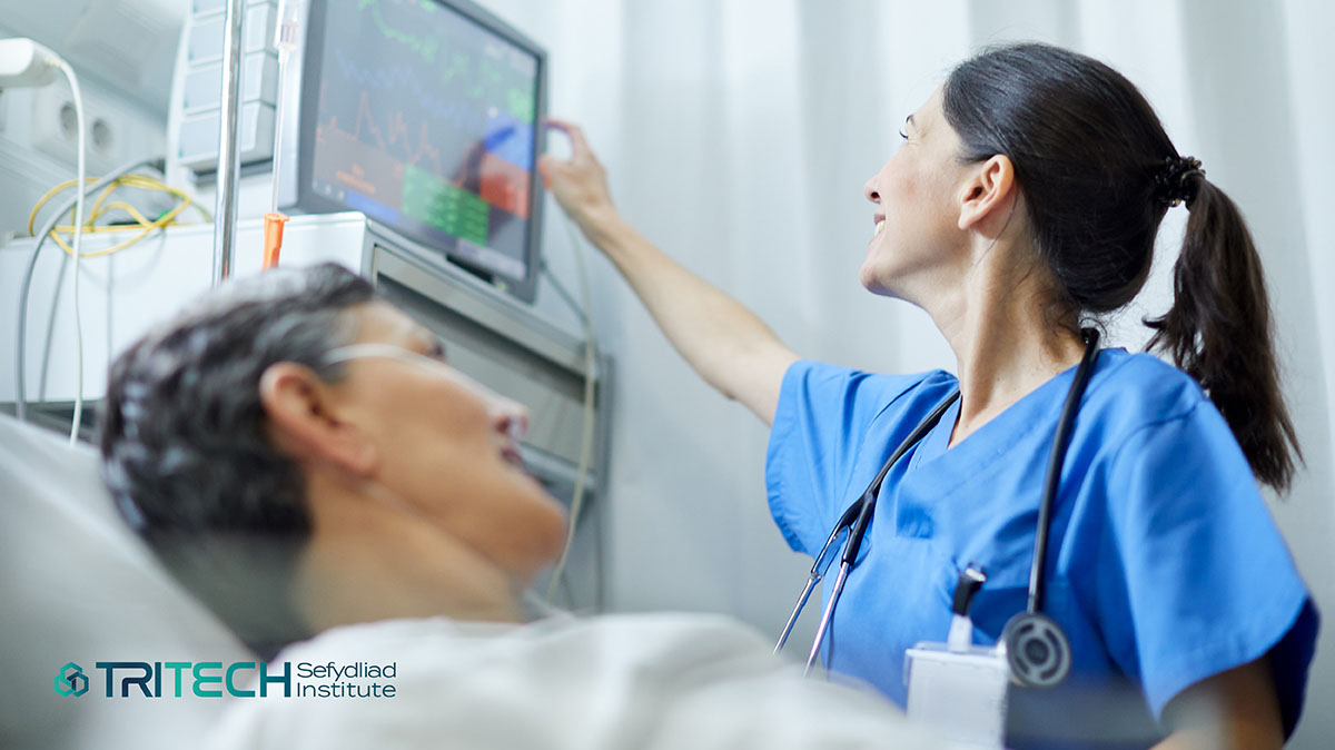 doctor monitoring a patients information on a display screen