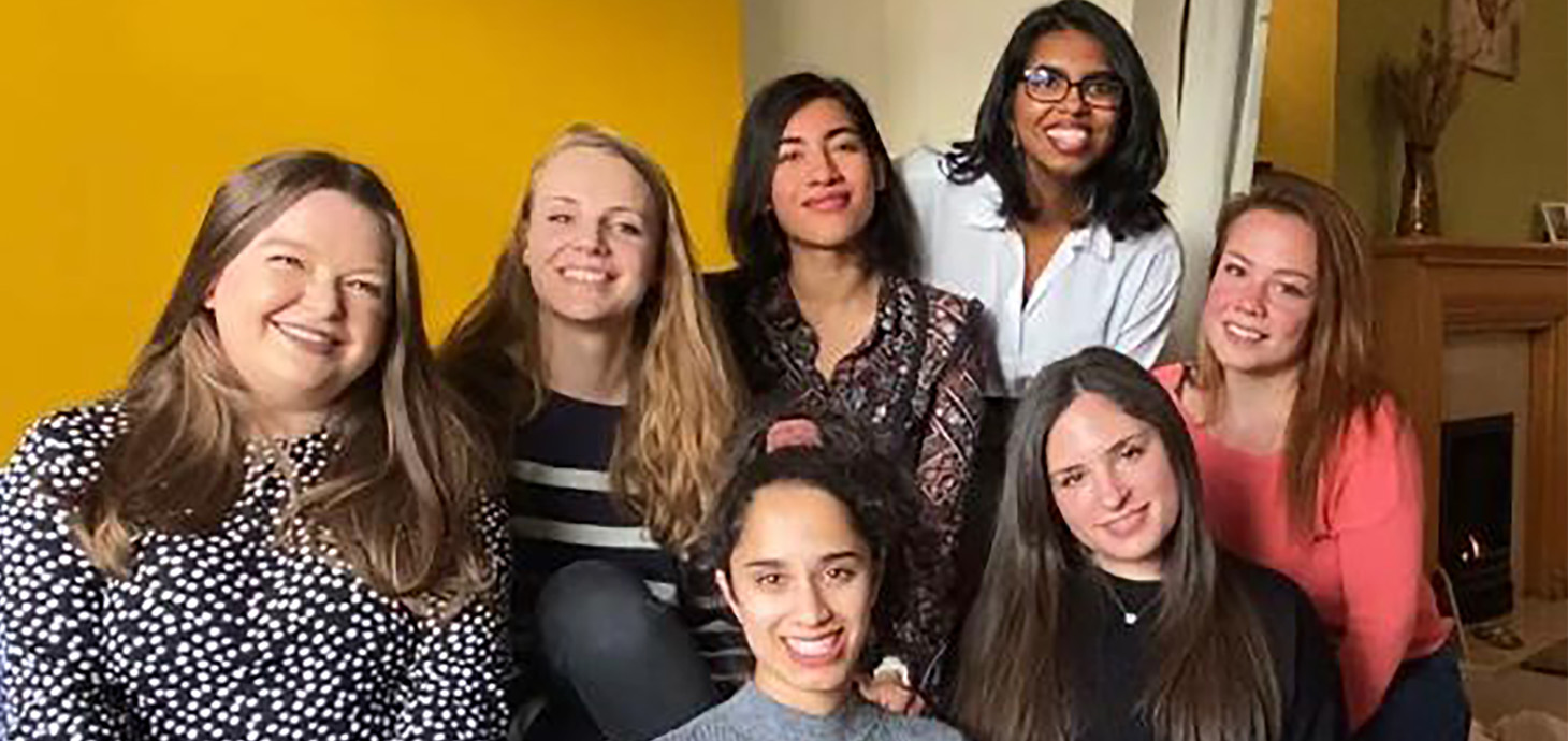 Group of medical students sitting together smiling. The Graduate Entry Medicine students from Swansea University who are offering to provide emergency relief childcare to Swansea health workers.