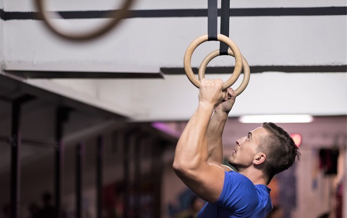 A gymnast on the rings: British athletes in Tokyo, including top medal winners, used wearable technology designed by Swansea University experts, with a printed carbon ink heater to keep their muscles warm before competing.