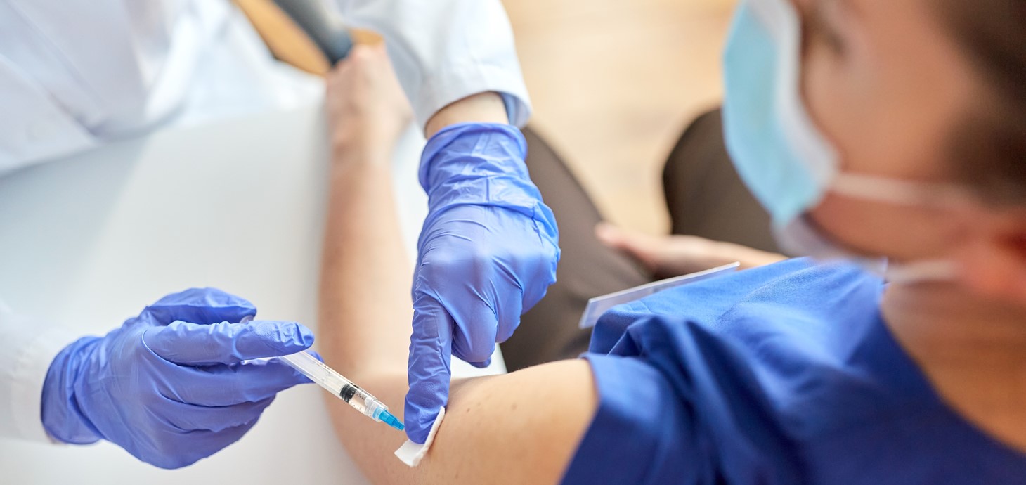 A doctor giving a vaccine to a patient.