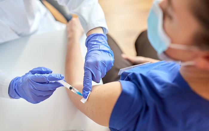 A doctor giving a vaccine to a patient.