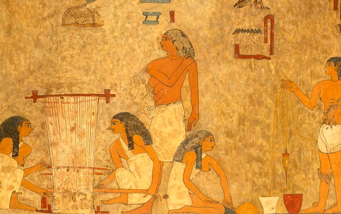 Faded painting of ancient Egyptians weaving cloth and spinning thread.