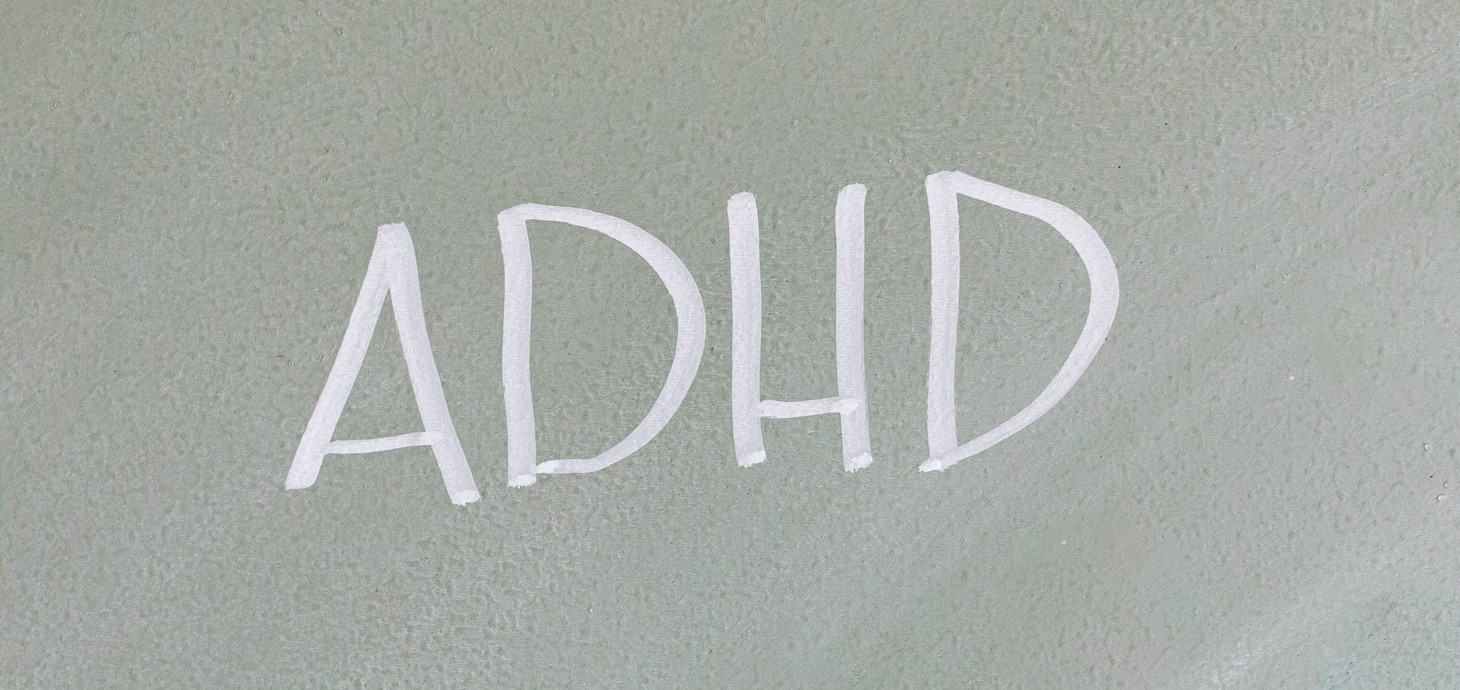 Chalkboard with the acronym ADHD written on it in chalk.