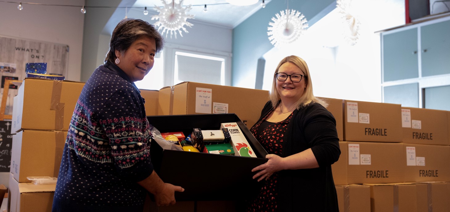 Audrey Reeve and Sarah Clifford holding one of the food hampers