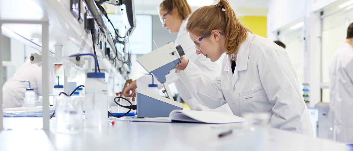 Female students working in a chemistry lab