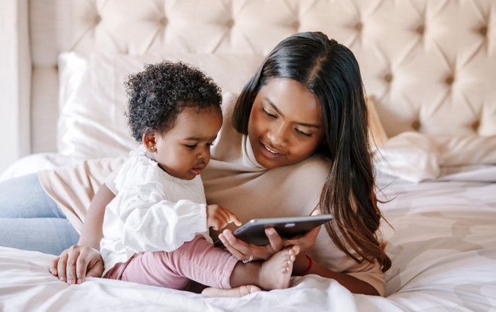 A toddler and mum using an iPad