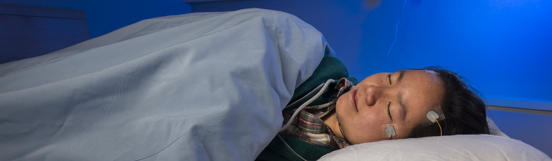 sleeping participant with electrodes attached to her head