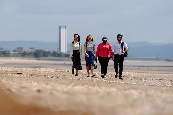 Students walking on the beach