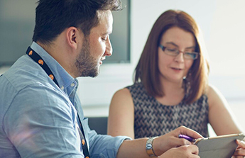 image of 2 members of staff in a meeting