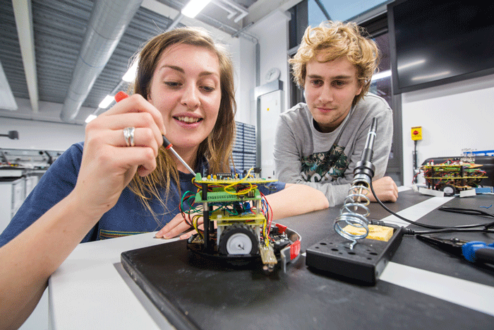 male and female student in electronics lab