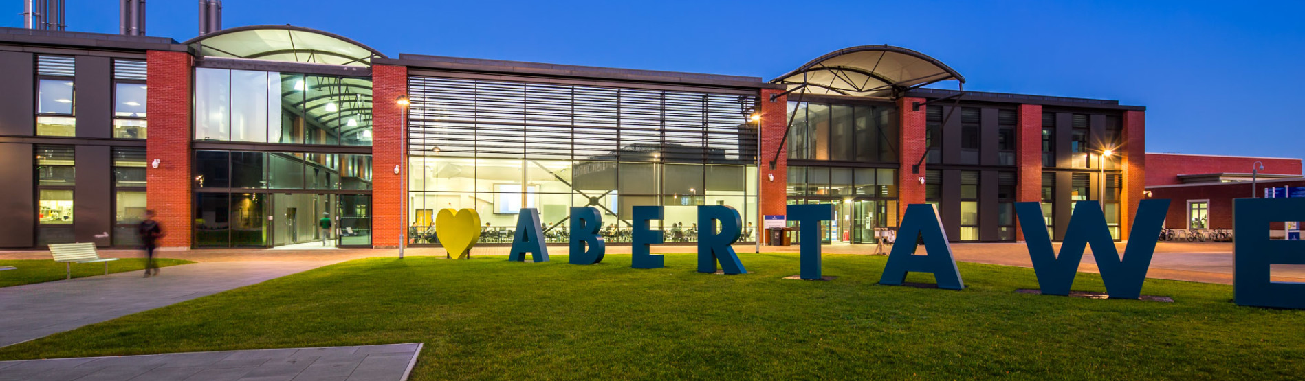 Bay Campus at night with I love Abertawe sign