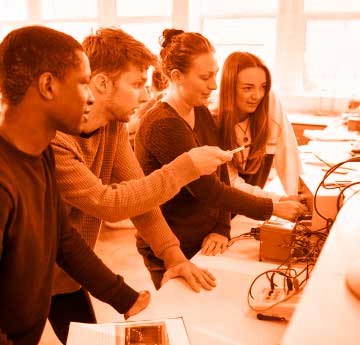 A group of male and female students discussing a science and engineering project