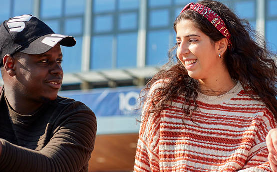 Students looking at each other and smiling