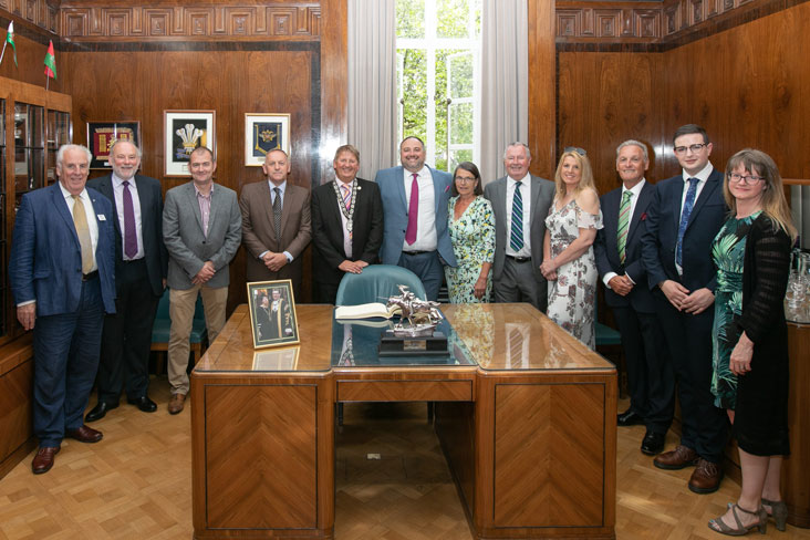 image of members around desk during the celebration Photo Credit: Liam Reardon