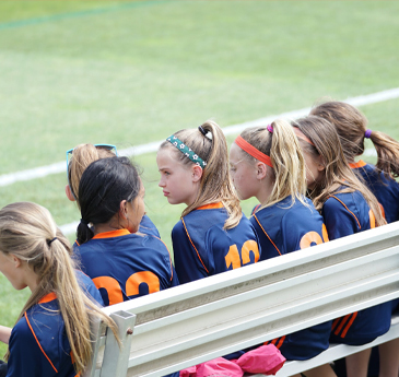 Schoolgirls waiting on a bench