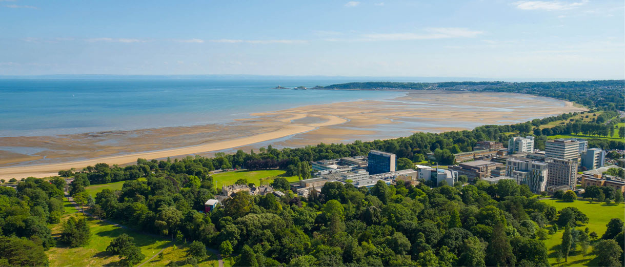 A view of singleton campus including singleton park and the beach, with the sea stretching into the horizon